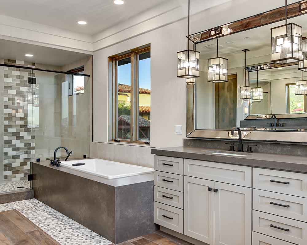 bathroom with bathtub and white cabinets gray and white centennial co